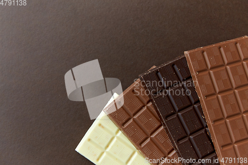 Image of different kinds of chocolate on brown background