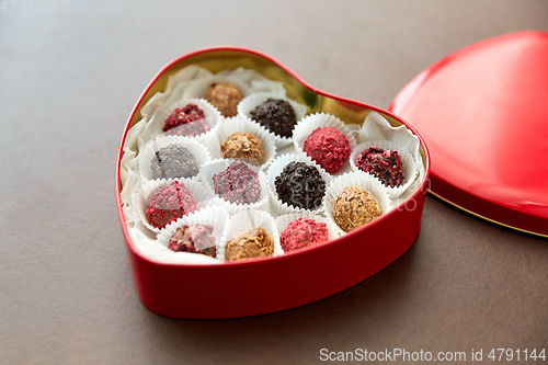 Image of candies in red heart shaped chocolate box