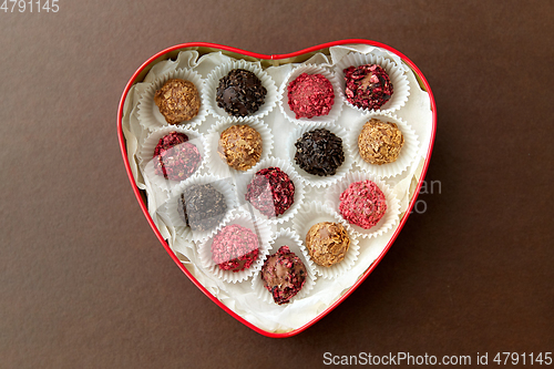 Image of candies in red heart shaped chocolate box