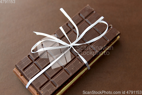 Image of different kinds of chocolate on brown background