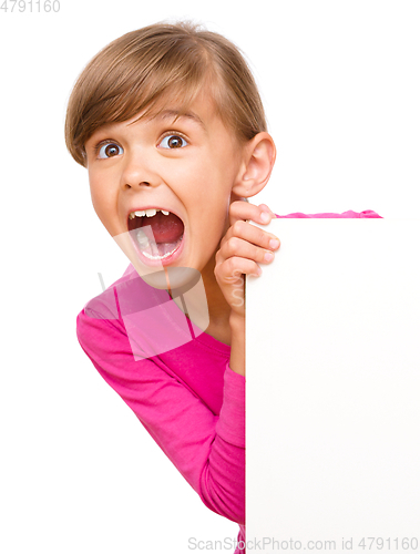 Image of Little girl is looking out from the blank banner