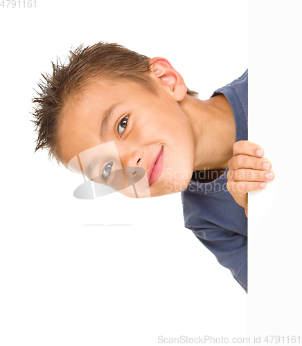 Image of Little boy is looking out from the blank banner