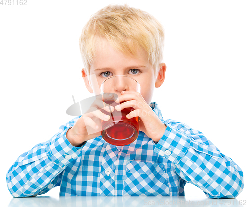 Image of Little boy with glass of cherry juice