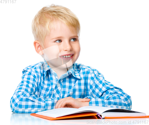 Image of Little child play with book