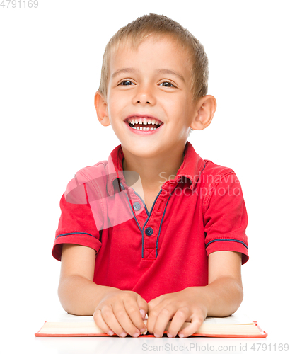 Image of Little boy is reading a book