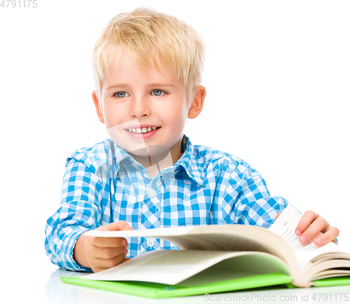 Image of Little child play with book