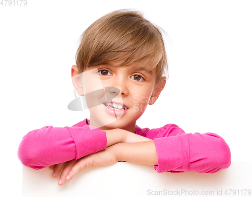 Image of Little girl is looking out from the blank banner