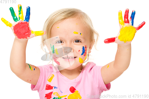 Image of Portrait of a cute little girl playing with paints