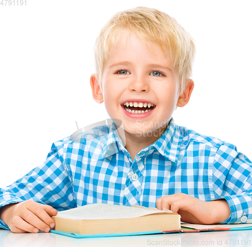 Image of Little child play with book