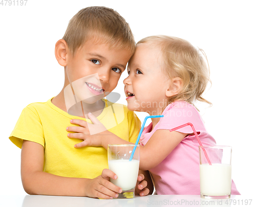 Image of Cute little girl and boy are drinking milk