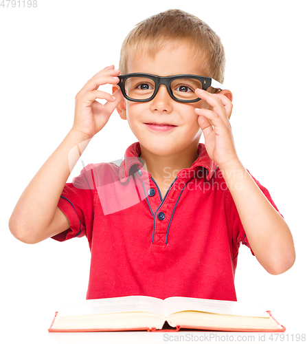 Image of Little boy is reading a book