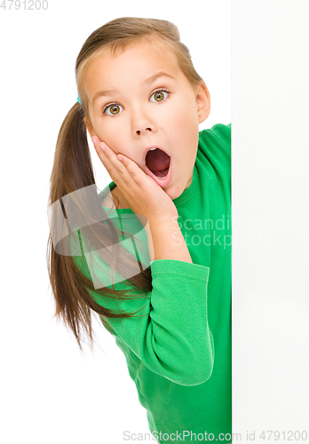 Image of Little girl is looking out from the blank banner