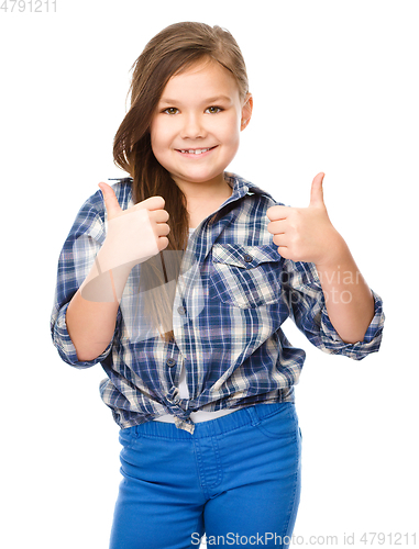 Image of Little girl is showing thumb up gesture