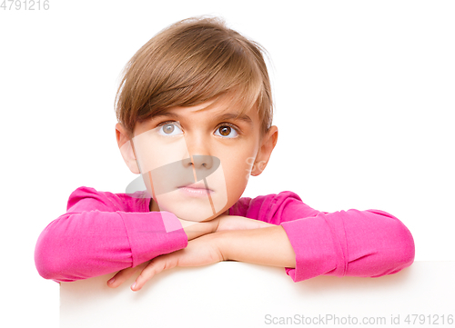 Image of Little girl is looking out from the blank banner