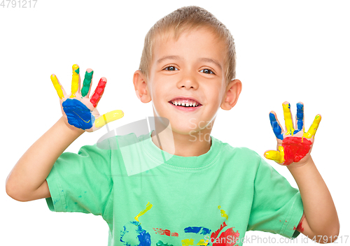 Image of Portrait of a cute boy playing with paints