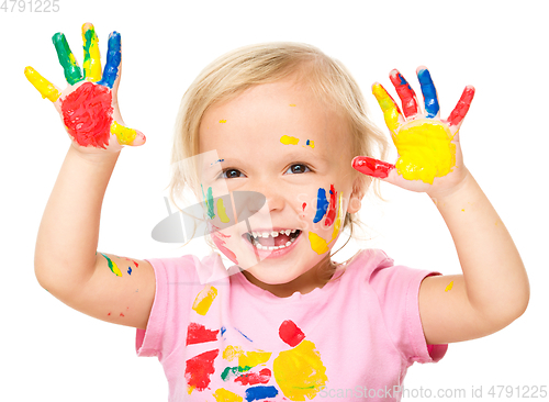 Image of Portrait of a cute little girl playing with paints