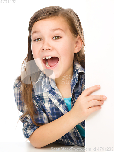 Image of Little girl is looking from out blank board