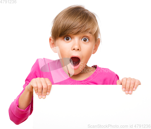 Image of Little girl is looking out from the blank banner