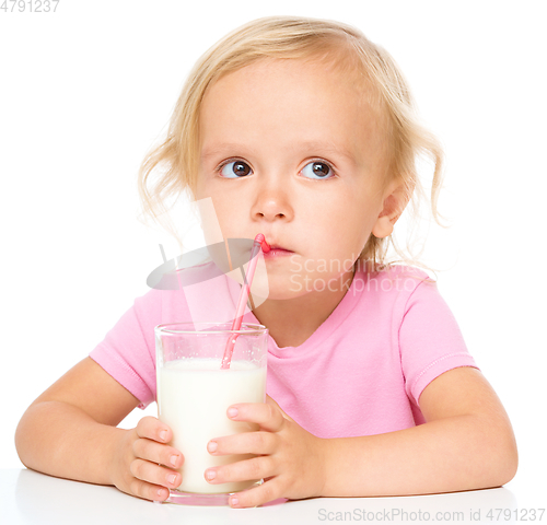 Image of Cute little girl with a glass of milk