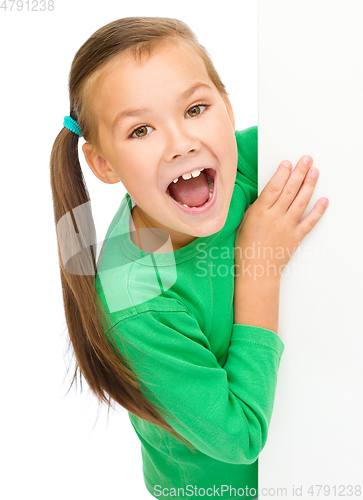 Image of Little girl is looking from out blank board