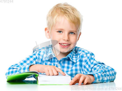 Image of Little child play with book