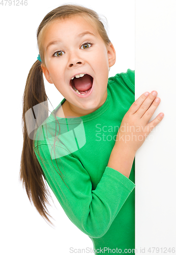 Image of Little girl is looking from out blank board