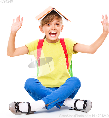 Image of Portrait of a cute little schoolgirl with backpack