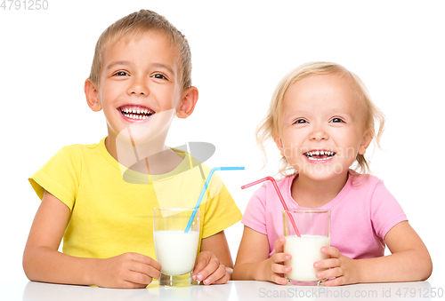 Image of Cute little girl and boy are drinking milk