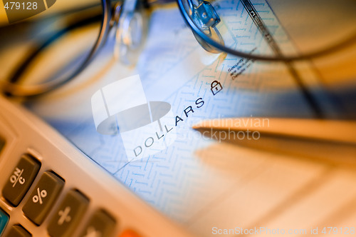Image of check , calculator and glasses