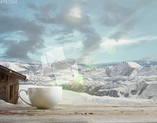 Image of Single tea or coffee mug and landscape of mountains on background