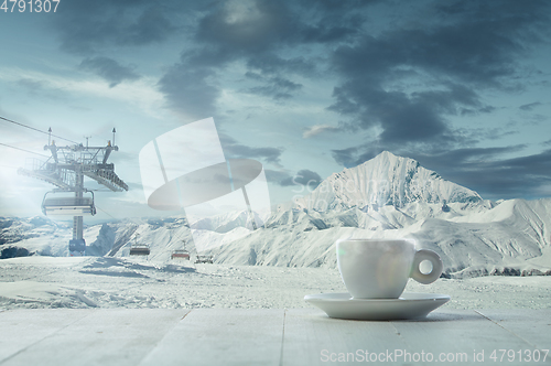 Image of Single tea or coffee mug and landscape of mountains on background