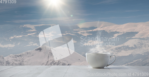 Image of Single tea or coffee mug and landscape of mountains on background