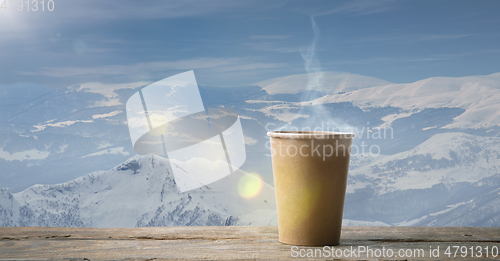 Image of Single tea or coffee mug and landscape of mountains on background