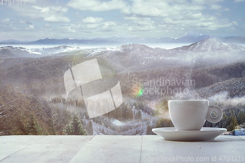 Image of Single tea or coffee mug and landscape of mountains on background