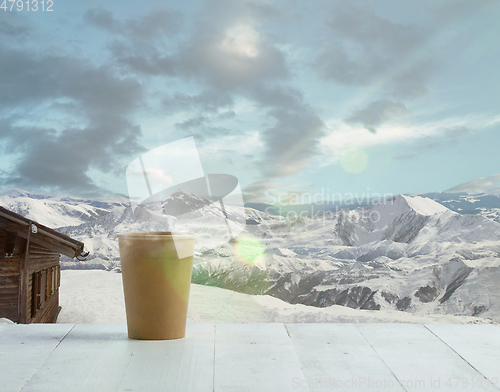 Image of Single tea or coffee mug and landscape of mountains on background