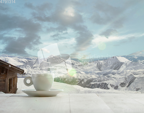 Image of Single tea or coffee mug and landscape of mountains on background