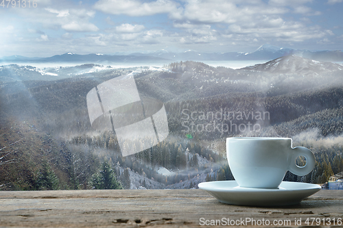 Image of Single tea or coffee mug and landscape of mountains on background