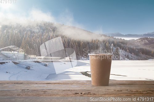 Image of Single tea or coffee mug and landscape of mountains on background