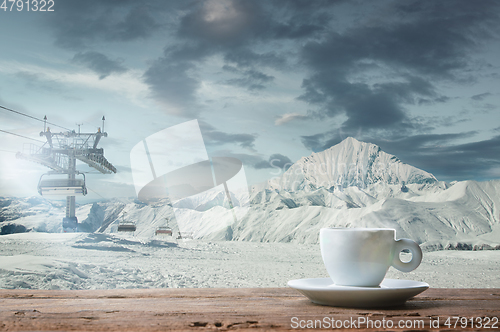 Image of Single tea or coffee mug and landscape of mountains on background