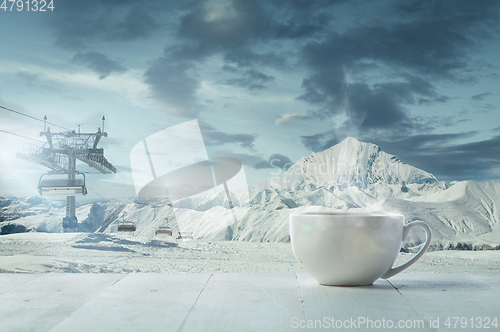 Image of Single tea or coffee mug and landscape of mountains on background