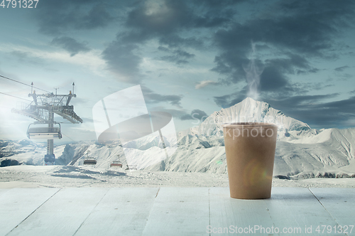 Image of Single tea or coffee mug and landscape of mountains on background