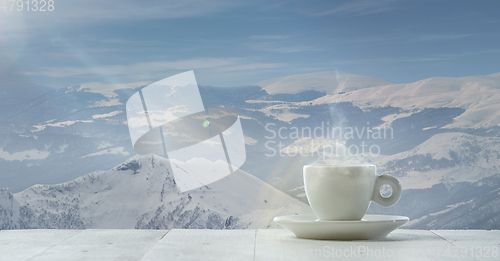 Image of Single tea or coffee mug and landscape of mountains on background