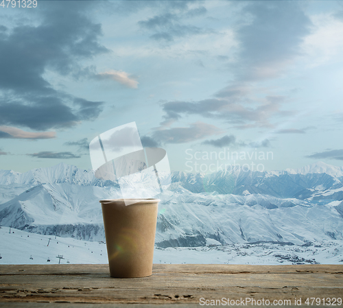 Image of Single tea aor coffee mug and landscape of mountains on background