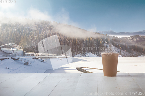 Image of Single tea or coffee mug and landscape of mountains on background