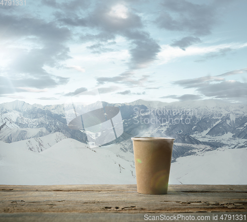 Image of Single tea or coffee mug and landscape of mountains on background