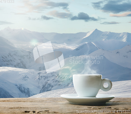 Image of Single tea or coffee mug and landscape of mountains on background