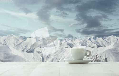 Image of Single tea or coffee mug and landscape of mountains on background