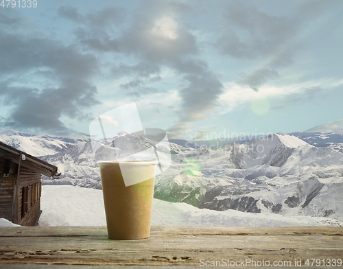 Image of Single tea or coffee mug and landscape of mountains on background