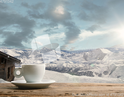 Image of Single tea or coffee mug and landscape of mountains on background