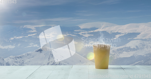 Image of Single tea or coffee mug and landscape of mountains on background